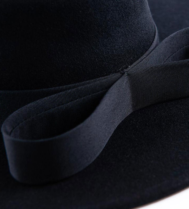 detail of black wide brim pork pie hat