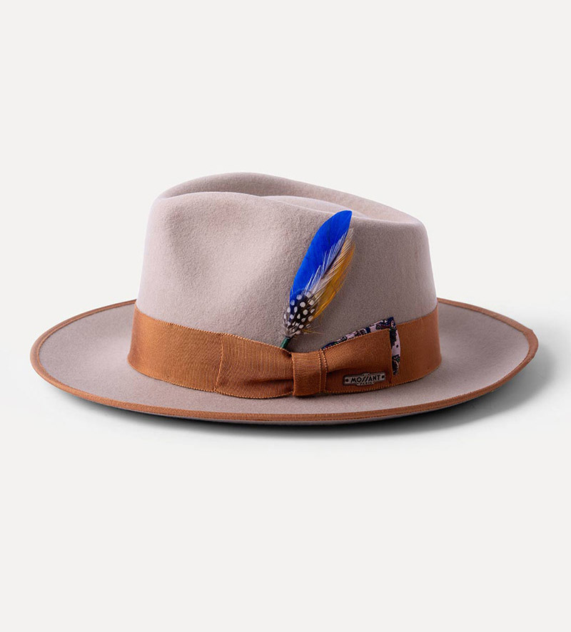 side view of beige teardrop fedora hat with feather