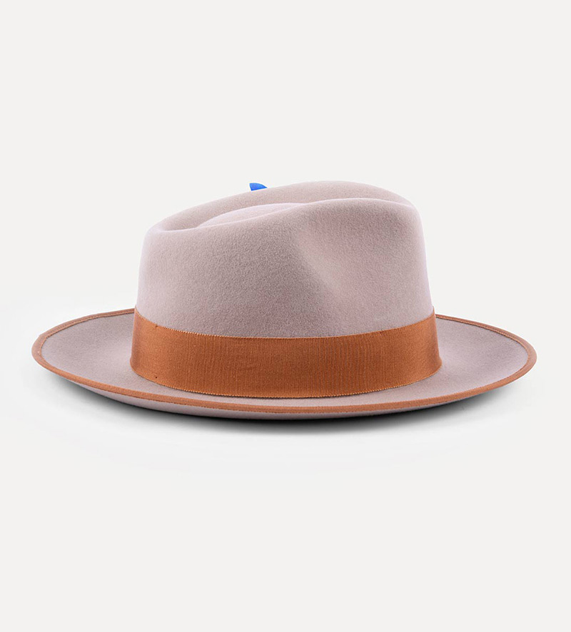 side view of beige teardrop fedora hat with feather