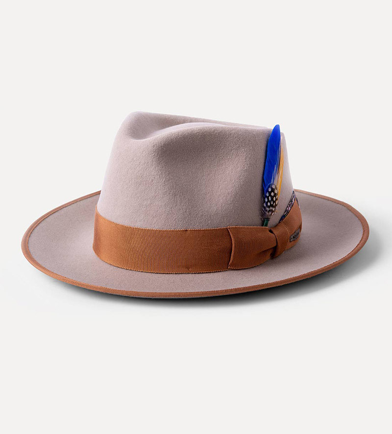 oblique view of beige teardrop fedora hat with feather