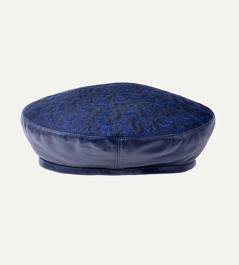 side view of womens blue leather beret