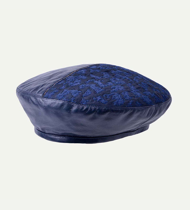 oblique view of womens blue leather beret